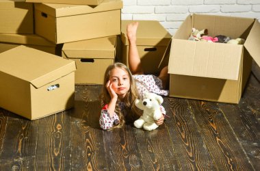 Her Yönde Görkemli Manzaralar. Oyuncağı olan mutlu küçük bir kız. Karton kutular yeni eve taşınıyor. Mutlu çocuk karton kutusu. Yeni evimizde oynuyoruz. Yeni daire. yeni konutun satın alınması