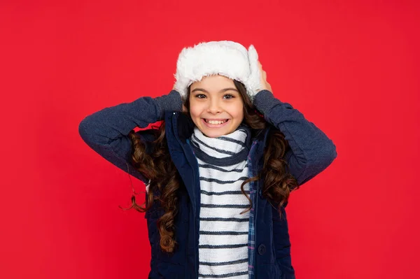 Express positive emotion. winter fashion. positive kid with curly hair in earflap hat. teen girl — Foto Stock