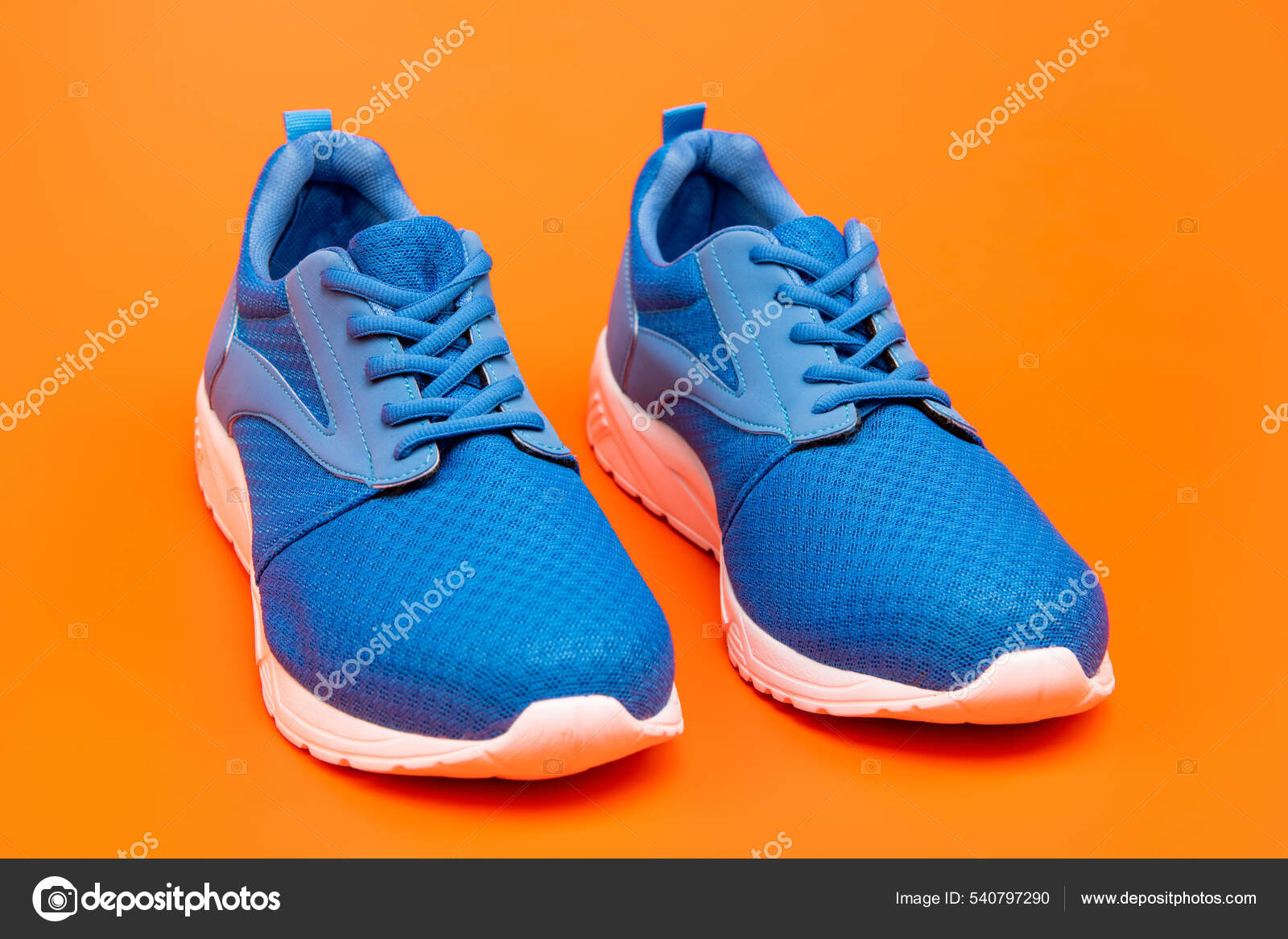 Sporty blue sneakers. shoes on orange background. shoe store. shopping ...