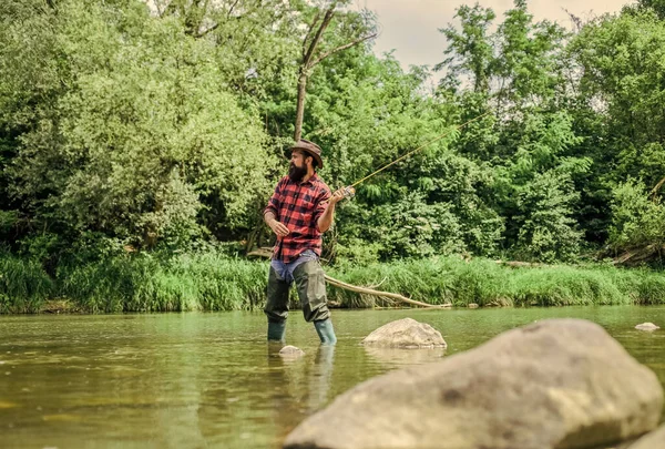 Experimenta la leyenda. pescador experimentado en el agua. hombre pescando peces. hombre maduro pesca con mosca. pescador mostrar técnica de pesca uso de la caña. Pesca con mosca exitosa. fin de semana de verano. actividad deportiva hobby — Foto de Stock