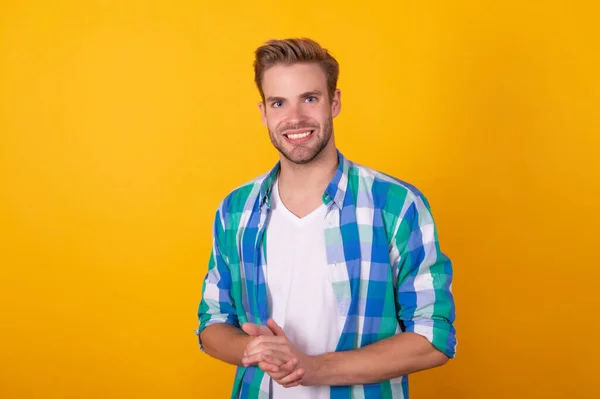 Handsome caucasian young man portrait happy smiling in checked shirt yellow background, guy — стоковое фото