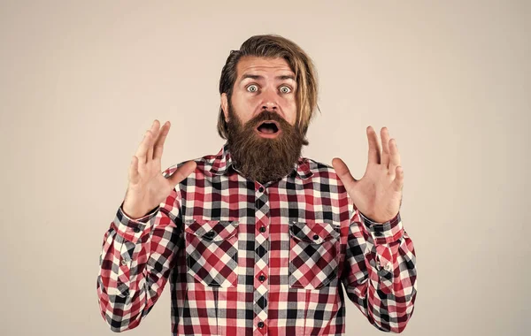 Oh my god. Portrait of bearded hipster. guy with long lush beard and mustache on face. handsome confident man has perfect hairstyle. surprised bearded man in checkered shirt. male beauty concept — Stock Photo, Image