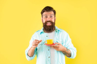 man in tuxedo bow tie with coffee cup. gentleman in formalwear smelling coffee on black background