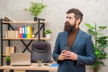 pondering brutal ceo in businesslike suit hold morning coffee cup at the office, to go