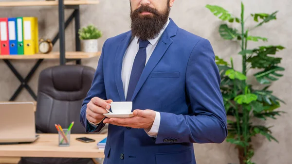 Cropped mature entrepreneur in jacket having coffee break at office, lunch break — Stock Photo, Image