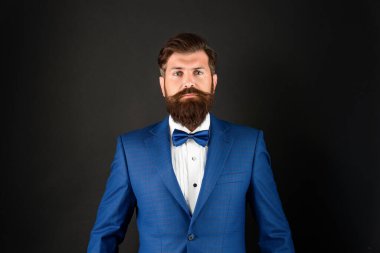 serious man in tuxedo bowtie. butler in formalwear on black background. male formal fashion