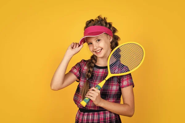 Sport giovanissima kid in fitness cap holding tennis o badminton racket, junior player — Foto Stock