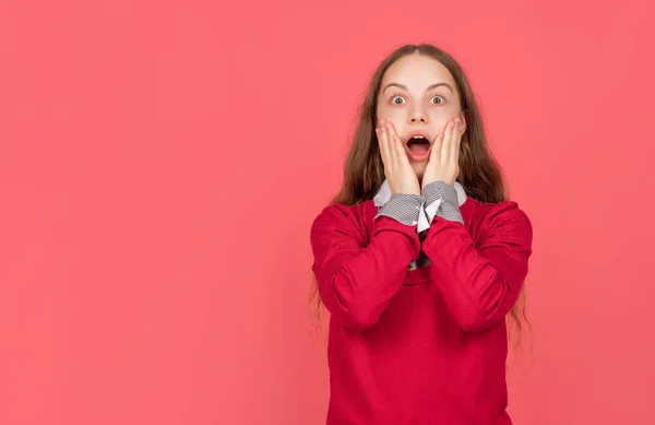 Shocked child in school uniform on red background with copy space, student — Stock Fotó