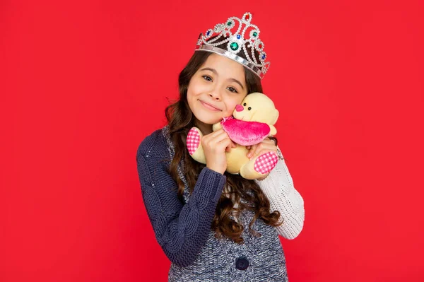 Happy lovely child in queen crown. princess in tiara. kid hold bear toy. teen girl — Fotografia de Stock