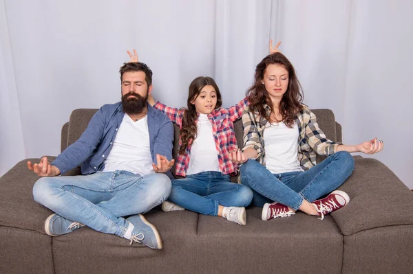 Parents with kid maditating together at home, yoga — Stock Fotó