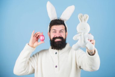 Join celebration. Bearded man wear bunny ears. Easter symbol concept. Easter shopping. Hipster cute rabbit long ears blue background. Easter bunny. Having fun. Funny bunny with beard and mustache