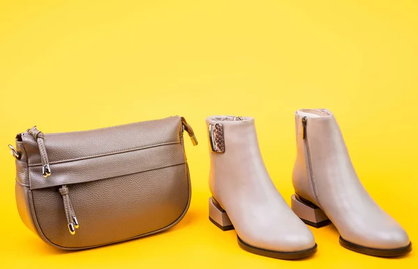 Beige boots. ankle boots on yellow background. shoe store. shopping concept. — Stock Photo, Image