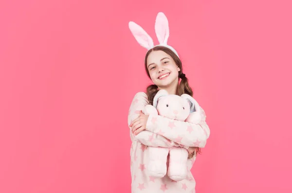 Feliz pascua adolescente chica en conejo conejo orejas y pijamas jugar con juguete, espacio de copia, Pascua —  Fotos de Stock