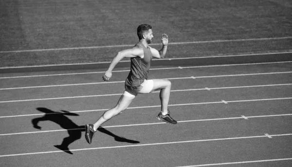 Full concentration. coach on stadium running track. endurance and stamina. runner on racetrack. challenge and competition. marathon speed. sport athlete run fast to win. successful fitness sprinter — Stock Photo, Image