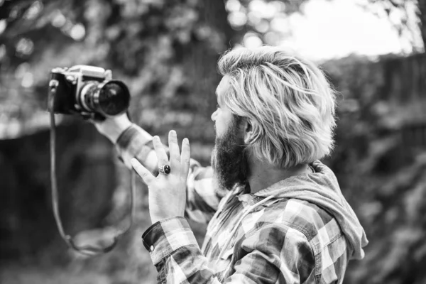 Photography in modern life. Use camera. Creating content for blog. Bearded man hipster taking photo. Hobby and professional occupation. Photographer and vintage camera. Man with retro camera — Stock Photo, Image