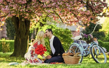 Aşık olduğum için mutluyum. Piknikteki romantik çift. İlkbaharda aşk randevusu. Sakura çiçeğinin altında rahatla. Birbirine aşık çiftler. Yıldönümü. Yaz parkında mutlu bir aile. Yiyecek ve içecek. Erkek ve kadın.