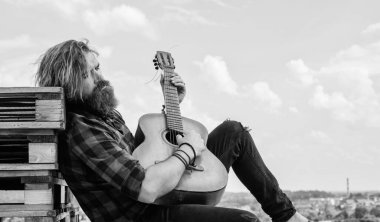 Akustik gitarist. Sakallı olgun hippi müzisyen. Gitar çalan vahşi beyaz adam. Country müziği. Sakallı adam şarkı söylüyor. Yakışıklı şarkıcı ve gitarist. Dinlenme zamanı.