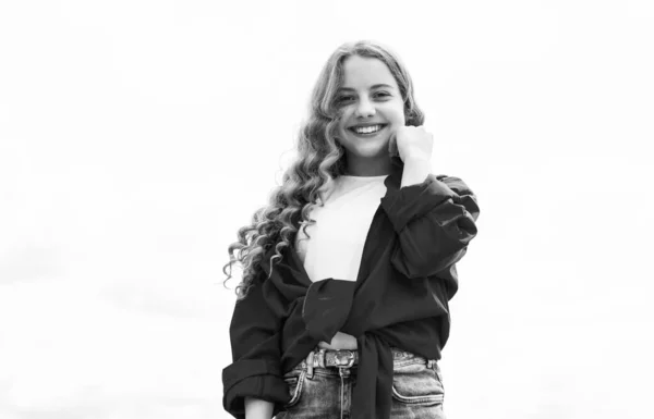 Infância feliz. menina adolescente alegre tem cabelo encaracolado longo. criança sorrindo ao ar livre. moda infantil e beleza. sentido de liberdade. retrato de menina bonita. conceito de futuro — Fotografia de Stock