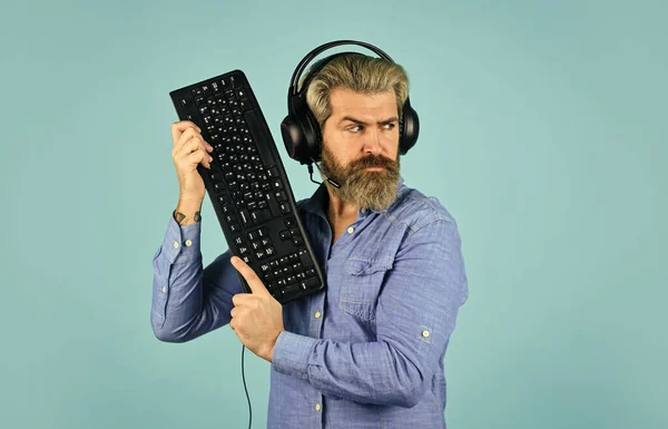 Gaming addiction. Man bearded hipster gamer headphones and keyboard. Play  computer games. Online gaming platform. Gaming modern leisure. Cyber sport  arena. Gaming PC build guide. Graphics settings Stock Photo by ©stetsik  510565044