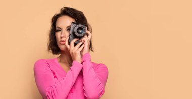Fotoğraf makinesinin fotokopi alanına bakan ciddi bir kız fotoğrafçının portresi.