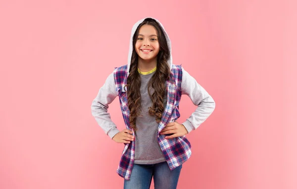 Positive kid with curly hair in hood on pink background, hipster — Stock Photo, Image