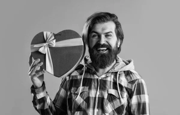 Hipster masculino barbudo em camisa quadriculada segurar presente caixa de coração, ser o meu dia dos namorados — Fotografia de Stock