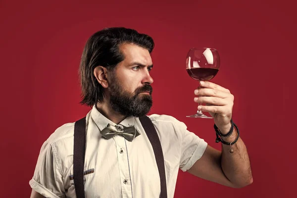 Handsome guy hipster with moustache and beard drinking wine, bar — Stock Photo, Image
