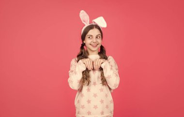 Neşeli ve kaygısız. Paskalya bahar tatili. Mutlu genç kız tavşan kulağı takıyor. Mutlu Paskalyalar.