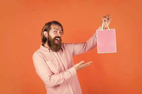 Para ti. hipster caucasiano brutal com presente. masculino ir às compras com a compra. Shopaholic bem sucedido. Homem barbudo pronto para as férias. venda e desconto. hipster maduro com barba segurar pacote presente — Fotografia de Stock