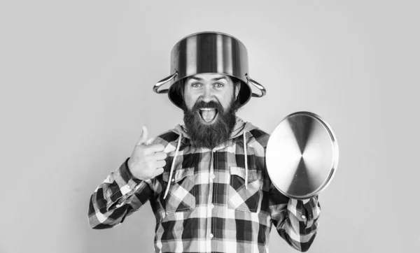 Male hipster with fashionable groomed hair and beard cooking with pan, chef — Stock Photo, Image