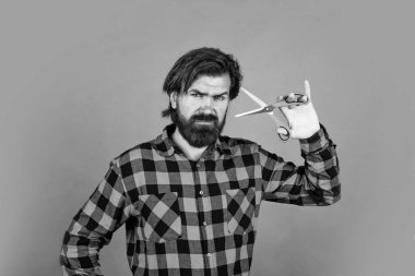 Sakallı hippi sakalını ve bıyığını kesti. Berber dükkanı. Berberler makas kullanır. Saç kesmek için makas kullanan moda bir adam. Kuaför salonundaki kendine güvenen adam. erkeklik ve karizma