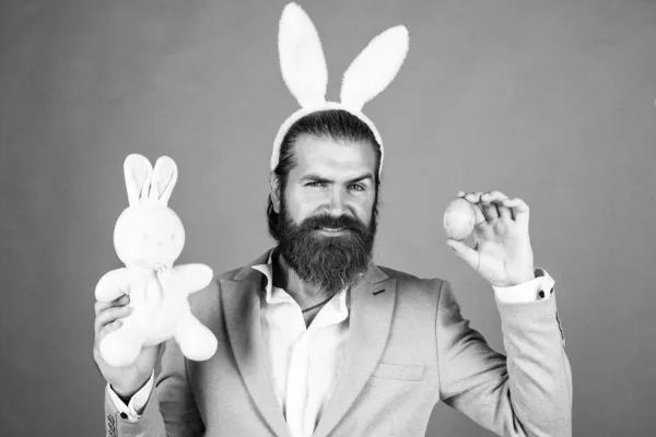 Easter decor. happy hipster with beard. Man in rabbit ears. Preparation for Easter. concept of egg hunt. Easter celebration concept. Man in bunny ears. rabbit man wear hare ears. bunny hunt begins