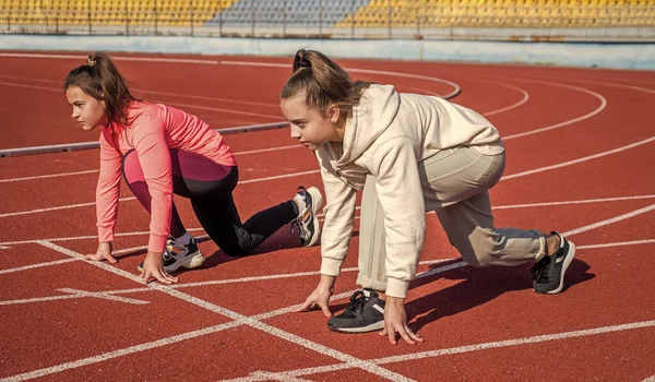 Girls kids standing on start before running outside on stadium arena, start — Stock Photo, Image