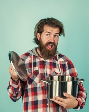 Vay canına. Elinde kızartma tavası olan bir adam... aşçı aşçı bir erkek. Sakallı adam aşçı için hippi damalı gömlek. Mutfak aletleriyle traşsız, vahşi bir adam. Ev eşyaları. Arkadaş canlısı tezgahtar