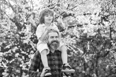 Dünya günü. Ekoloji ve çevre. Basit mutluluk. Mutlu bir aile. Babalık mutluluğu. Babalar Günü. Doğada yaşayan küçük bir çocuk ve baba. Hippi ve küçük oğlu. Mutluluk kavramı. Bahar yürüyüşü