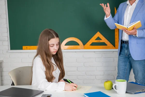 Child study in classroom with cropped teacher — Stock Photo, Image