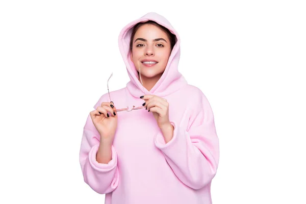 Fashion woman happy smiling holding glasses in hands in casual pink hoodie isolated on white — ストック写真