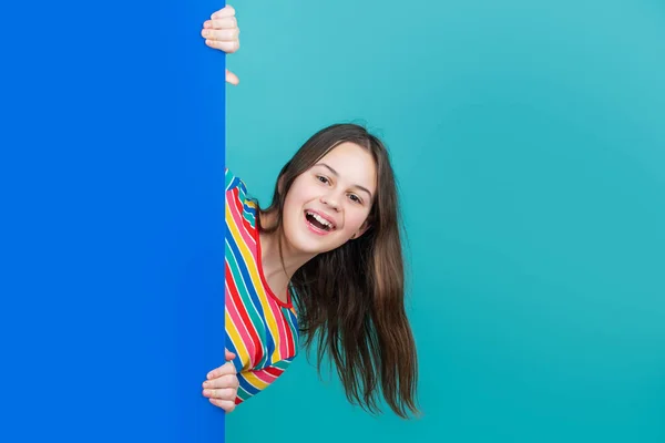 Laughing kid behind blank blue paper with copy space for advertisement — 스톡 사진