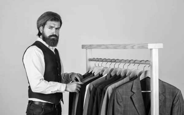 Bearded man customer looking for his size formal suit, vintage stock concept — Stock Photo, Image