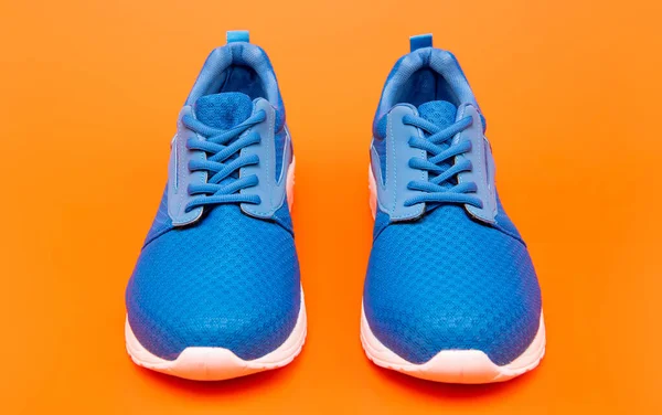 Pair of comfortable sport shoes. sporty blue sneakers. shoes on orange background. — 스톡 사진