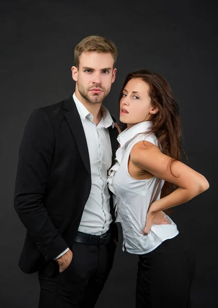 man and woman in business look on black background, businesspeople