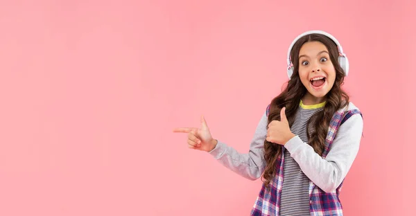 Ouvir música. apontando o dedo no espaço de cópia. nova tecnologia. desenvolvimento infantil. — Fotografia de Stock