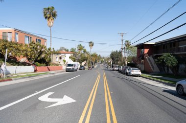 Long Beach, California USA - April 01, 2021: road marks on street in suburban neighborhood with parked cars