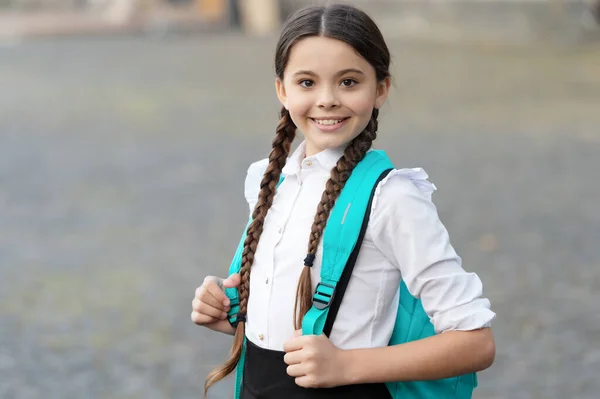 Happy braided girl with backpack in school uniform — Stok fotoğraf