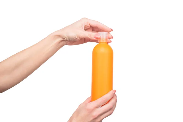 Female hands hold cosmetic bottle with copy space — 스톡 사진