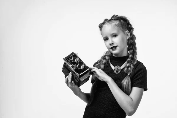 Teen girl making photo. retro camera. happy childhood. kid has elegant look. photography in modern life. child with old fashioned photo camera isolated on white. vintage technology. copy space — Stock Photo, Image