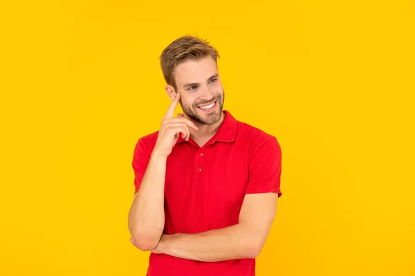 Happy man in red shirt on yellow background, casual — Zdjęcie stockowe