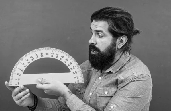 Hombre sorprendido con el tamaño medido en la herramienta matemática regla transportador, disciplinas de tallo escolar — Foto de Stock