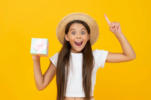 Inspired teen child hold present box on yellow background — Stock Fotó