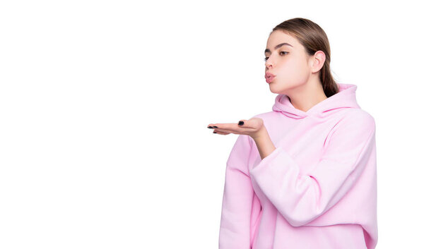 girl in pink hoodie isolated on white background. blow kiss